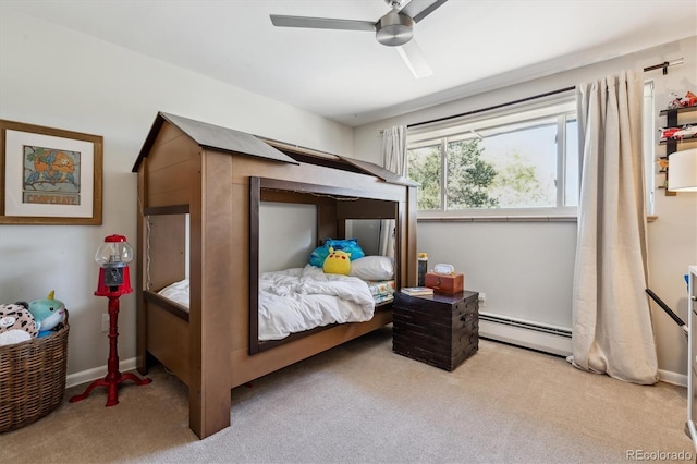 bedroom with baseboard heating, carpet flooring, and a ceiling fan