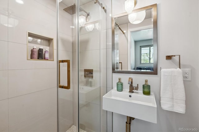 bathroom featuring a stall shower and a sink