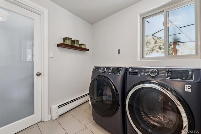 laundry area featuring a baseboard heating unit, separate washer and dryer, light tile patterned floors, and baseboards