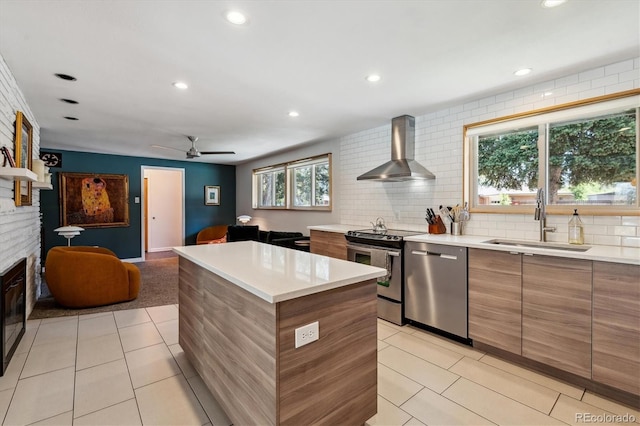 kitchen featuring wall chimney exhaust hood, stainless steel appliances, a sink, modern cabinets, and light tile patterned floors