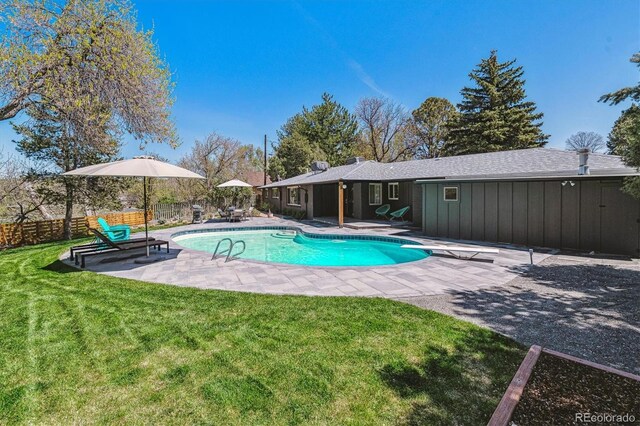 view of swimming pool with a patio and a diving board