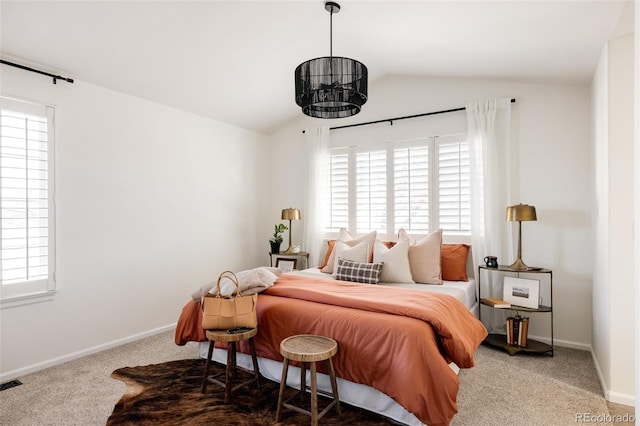 bedroom with lofted ceiling and carpet flooring