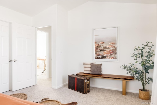 carpeted home office with vaulted ceiling