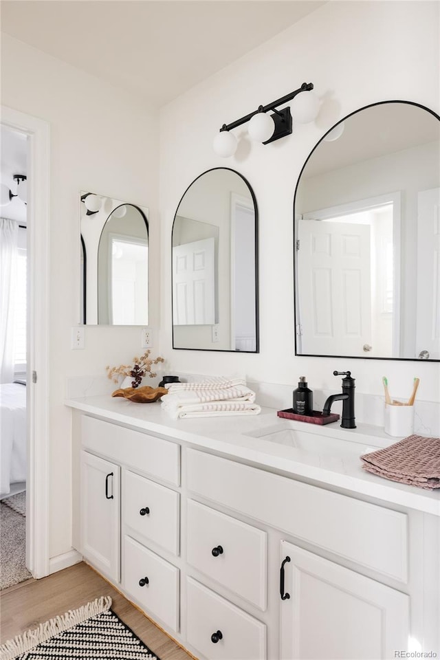 bathroom with vanity and wood-type flooring