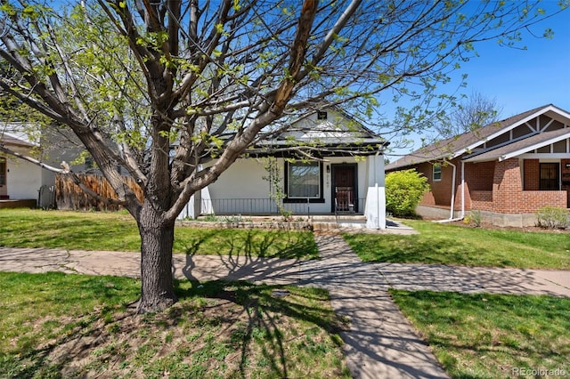 3147 W 39th Ave, Denver, CO 80211 - view of front facade with a porch, a front lawn, and brick siding