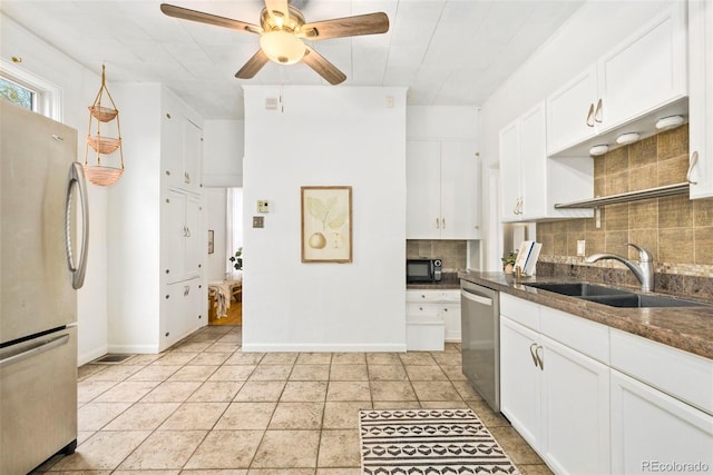 3147 W 39th Ave, Denver, CO 80211 - kitchen featuring stainless steel appliances, a sink, backsplash, ceiling fan, and white cabinetry