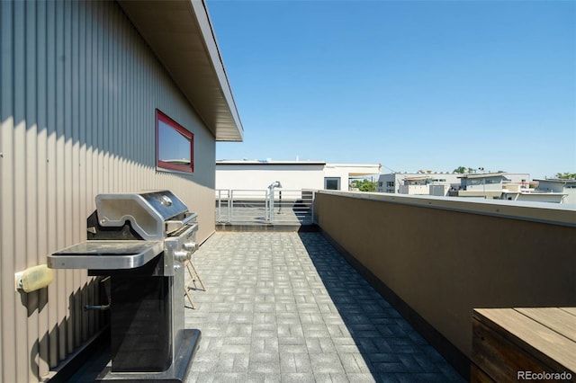 view of patio featuring grilling area and a balcony