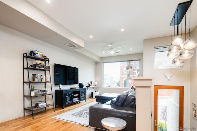 living room with hardwood / wood-style flooring and ceiling fan