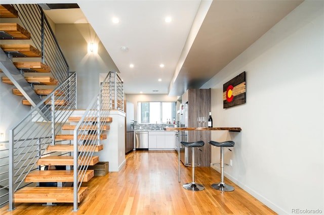 stairway with hardwood / wood-style floors