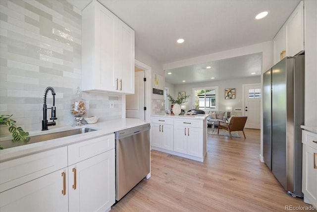 3216 Elizabeth, Denver, CO 80205 - kitchen featuring stainless steel appliances, a sink, light countertops, decorative backsplash, and recessed lighting