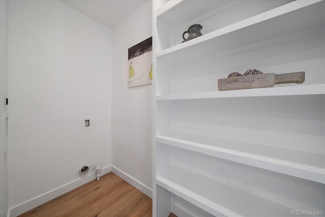3216 Elizabeth, Denver, CO 80205 - laundry area with light wood-style flooring and baseboards