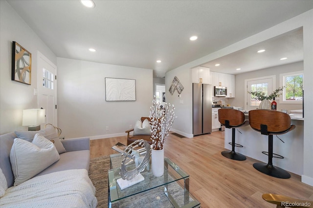 3216 Elizabeth, Denver, CO 80205 - living room featuring recessed lighting, light wood finished floors, and baseboards