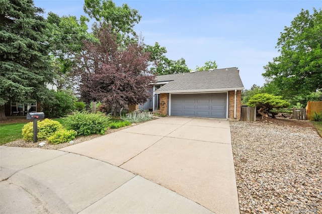 8413 E Jamison Cir, Englewood, CO 80112 - obstructed view of property featuring driveway, brick siding, a garage, and roof with shingles
