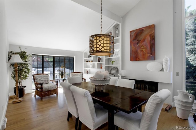 8413 E Jamison Cir, Englewood, CO 80112 - dining room with vaulted ceiling, wood finished floors, and built in shelves