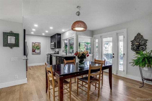 8413 E Jamison Cir, Englewood, CO 80112 - dining area with light wood-style floors and recessed lighting