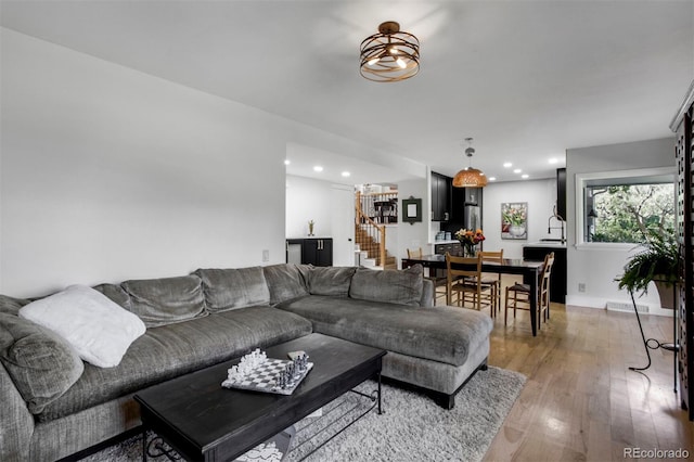8413 E Jamison Cir, Englewood, CO 80112 - living room featuring light wood finished floors and recessed lighting