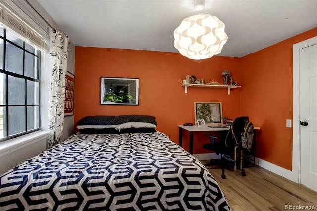 8413 E Jamison Cir, Englewood, CO 80112 - bedroom featuring wood finished floors, multiple windows, and a desk