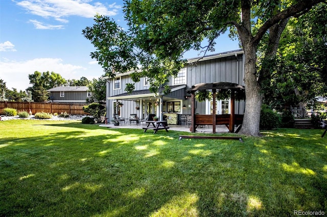 8413 E Jamison Cir, Englewood, CO 80112 - back of property featuring a patio area and board and batten siding