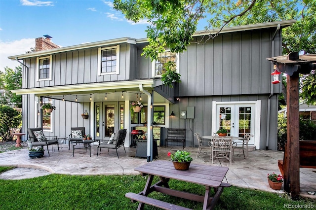 8413 E Jamison Cir, Englewood, CO 80112 - rear view of property with french doors, a chimney, and a patio