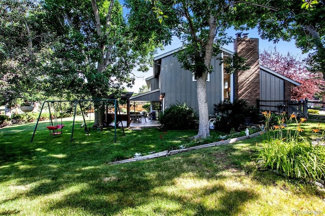 8413 E Jamison Cir, Englewood, CO 80112 - view of yard featuring a playground and a patio area