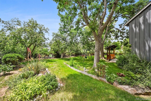8413 E Jamison Cir, Englewood, CO 80112 - view of grassy yard with a playground