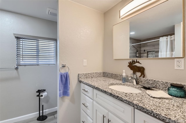 bathroom with vanity and curtained shower