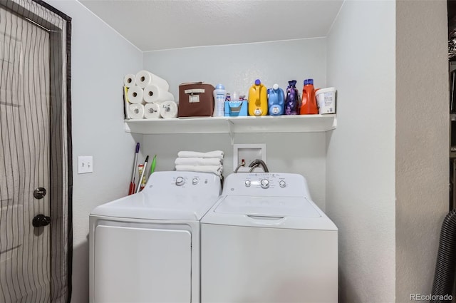 washroom featuring washer and dryer and a textured ceiling