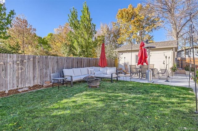 view of yard with a patio and an outdoor living space with a fire pit