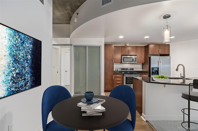 dining room with wood-type flooring and sink