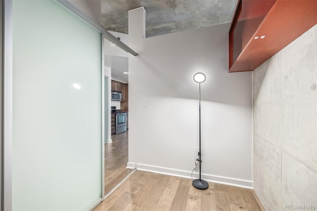 interior space with wood-type flooring and stainless steel appliances