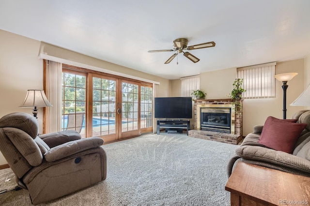living area with carpet, french doors, a fireplace, and ceiling fan