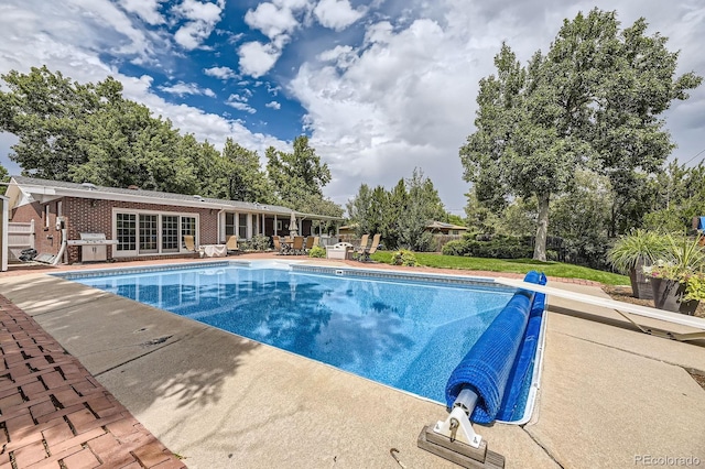 view of pool with a patio area, a fenced in pool, and fence