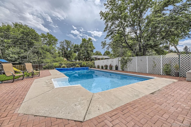 view of swimming pool with a patio, a fenced in pool, and a fenced backyard