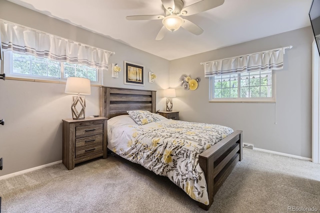 carpeted bedroom with a ceiling fan and baseboards