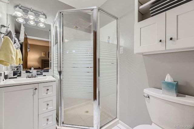 full bath featuring toilet, vanity, and a stall shower