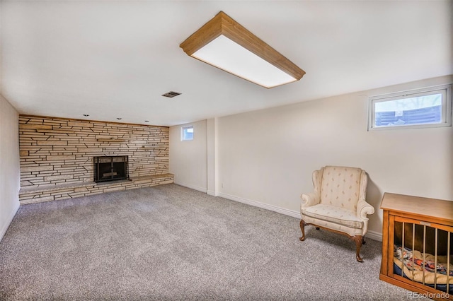 sitting room with carpet, a fireplace, visible vents, and plenty of natural light