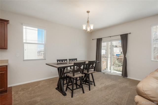 6434 N Ensenada Ct, Aurora, CO 80019 - dining room featuring baseboards, a chandelier, and light carpet