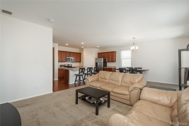 6434 N Ensenada Ct, Aurora, CO 80019 - carpeted living room with baseboards, recessed lighting, a chandelier, and visible vents