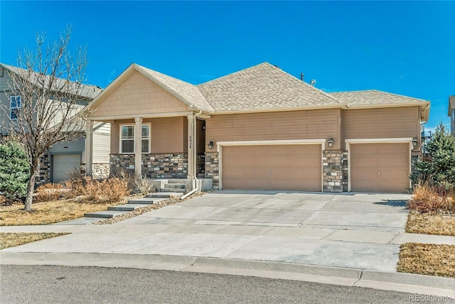 6434 N Ensenada Ct, Aurora, CO 80019 - view of front facade featuring a garage, covered porch, driveway, and stone siding