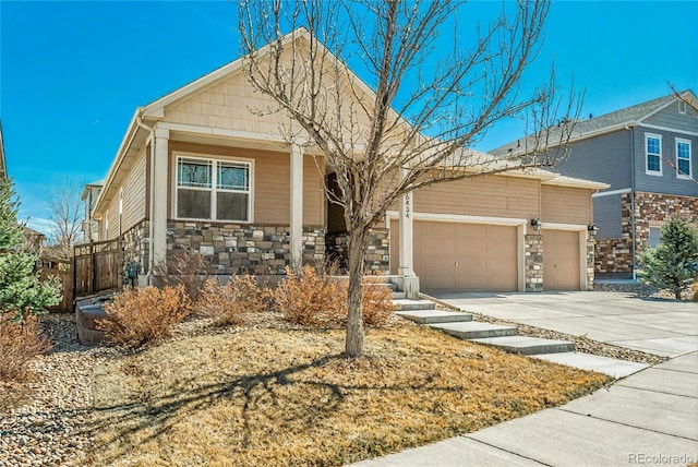 6434 N Ensenada Ct, Aurora, CO 80019 - ranch-style house with concrete driveway, an attached garage, covered porch, and stone siding