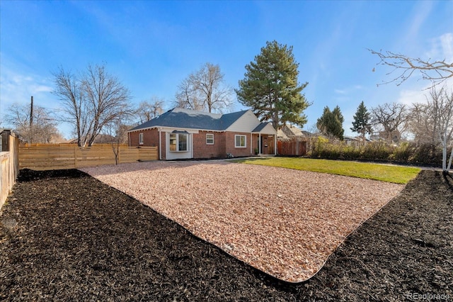 back of house with a lawn