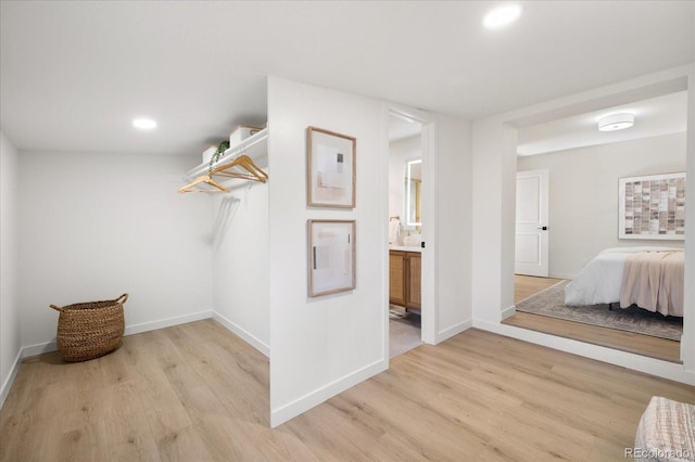 walk in closet featuring light hardwood / wood-style flooring