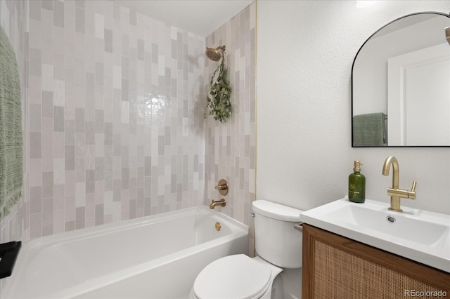 full bathroom with tiled shower / bath, vanity, and toilet