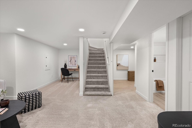 staircase featuring carpet floors