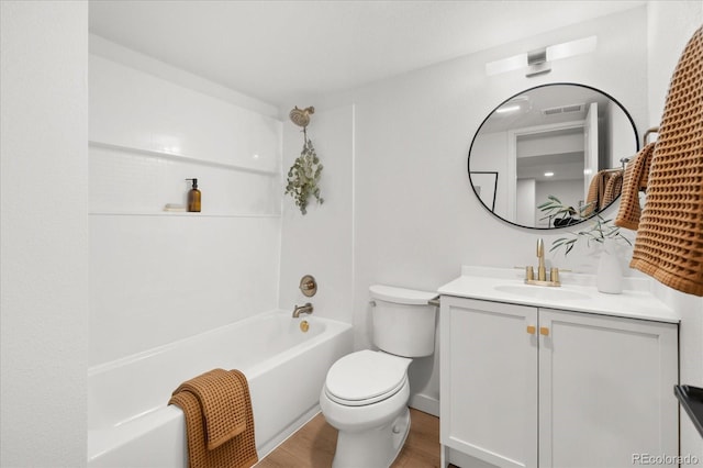 full bathroom with hardwood / wood-style flooring, vanity, toilet, and bathtub / shower combination