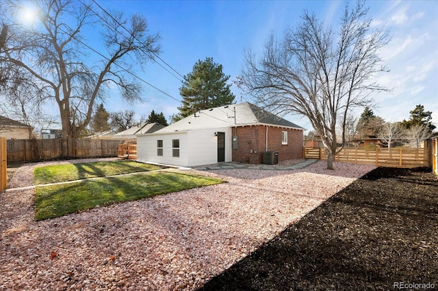 back of house with a lawn, central AC, and a patio area