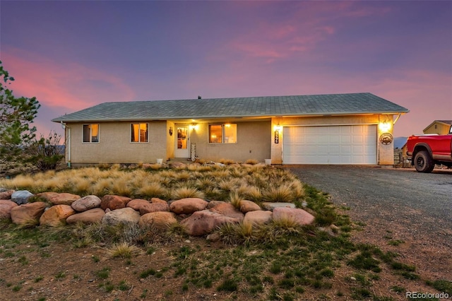 3569 County Road 19, Florence, CO 81226 - single story home featuring a garage, gravel driveway, and stucco siding