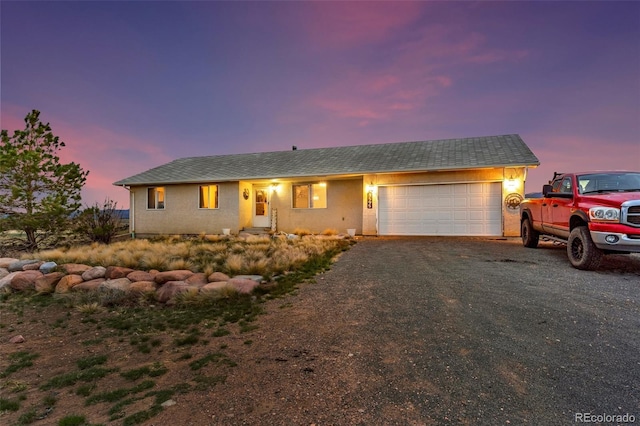 3569 County Road 19, Florence, CO 81226 - single story home with a garage, asphalt driveway, and stucco siding