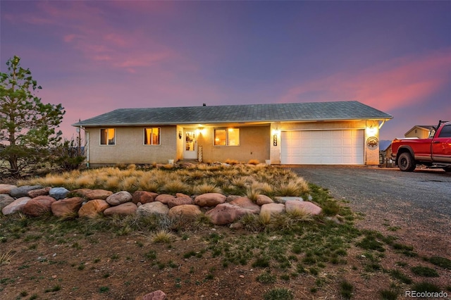 3569 County Road 19, Florence, CO 81226 - single story home featuring a garage, gravel driveway, and stucco siding
