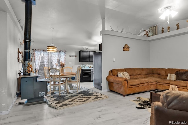 3569 County Road 19, Florence, CO 81226 - living area with a wood stove, baseboards, and vaulted ceiling